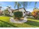 Charming home featuring tropical landscaping, a screened-in porch and well-maintained lawn at 3819 Aves Island Ct, Punta Gorda, FL 33950
