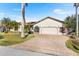 Charming single-story home featuring a brick driveway, well-maintained lawn, and an attached two-car garage at 3819 Aves Island Ct, Punta Gorda, FL 33950