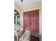 Inviting front entrance with double doors, decorative hardware, and a cozy wicker chair on the porch at 3819 Aves Island Ct, Punta Gorda, FL 33950
