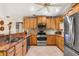 Well-lit kitchen featuring wooden cabinets, stainless steel appliances, and a large stainless steel refrigerator at 3819 Aves Island Ct, Punta Gorda, FL 33950