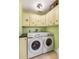 Laundry room featuring a Samsung washing machine and dryer with painted cabinets at 3819 Aves Island Ct, Punta Gorda, FL 33950