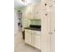 Laundry room with painted cabinets, tile flooring, and granite countertop at 3819 Aves Island Ct, Punta Gorda, FL 33950
