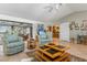 Comfortable living room featuring tile floors, ceiling fan, and an archway leading into the kitchen at 3819 Aves Island Ct, Punta Gorda, FL 33950