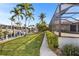 A lush tropical landscaped yard leads to a waterway and private boat dock at 3819 Aves Island Ct, Punta Gorda, FL 33950