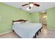 Spacious bedroom featuring tile floors, ceiling fan, and a comfortable bed at 420 Zephyr Rd, Venice, FL 34293