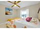 Bedroom with ceiling fan, natural light and a colorful painting at 420 Zephyr Rd, Venice, FL 34293