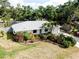 Charming home with lush landscaping, palm trees, a long driveway and an attached one car garage at 420 Zephyr Rd, Venice, FL 34293