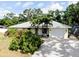 Charming home with lush landscaping, palm trees, a long driveway and an attached one car garage at 420 Zephyr Rd, Venice, FL 34293