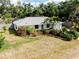 Charming home with lush landscaping, palm trees, a long driveway and an attached one car garage at 420 Zephyr Rd, Venice, FL 34293