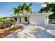Charming single Gathering home boasts a long driveway, one car garage, and beautiful landscaping at 420 Zephyr Rd, Venice, FL 34293