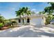 Charming single Gathering home boasts a long driveway, one car garage, and beautiful landscaping at 420 Zephyr Rd, Venice, FL 34293