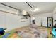 Large garage featuring ample storage space, colorful floor, and convenient access to the rest of the house at 420 Zephyr Rd, Venice, FL 34293
