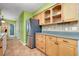 Bright kitchen featuring wood cabinets, stainless steel appliances, tile flooring, and neutral countertops at 420 Zephyr Rd, Venice, FL 34293