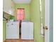 Laundry room with matching white washer and dryer, storage cabinets, tile flooring, and neutral paint at 420 Zephyr Rd, Venice, FL 34293