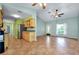 Open floor plan with tile flooring, neutral paint, ceiling fans, and lots of natural light at 420 Zephyr Rd, Venice, FL 34293