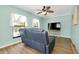 Bright living room features modern ceiling fan, laminate floors, and ample natural light through the windows at 420 Zephyr Rd, Venice, FL 34293