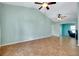 Expansive living area with tile flooring and a relaxing paint scheme, complemented by a ceiling fan at 420 Zephyr Rd, Venice, FL 34293