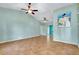 Open concept living room with ample space, vaulted ceilings, ceiling fans, and refreshing wall color at 420 Zephyr Rd, Venice, FL 34293