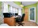 Home office space with abundant natural light, neutral paint, tile flooring, and storage cabinets at 420 Zephyr Rd, Venice, FL 34293