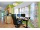 Home office space with abundant natural light, neutral paint, tile flooring, and modern appliances at 420 Zephyr Rd, Venice, FL 34293