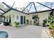 Covered patio with an outdoor seating area and lush potted plants at 420 Zephyr Rd, Venice, FL 34293