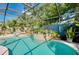 Custom pool with mature landscaping within screened-in pool enclosure, perfect for outdoor relaxation and entertaining at 420 Zephyr Rd, Venice, FL 34293