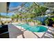 Screened-in pool area with custom pool, patio, mature landscaping, and inviting backyard for entertaining at 420 Zephyr Rd, Venice, FL 34293