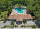 Aerial view of community pool and clubhouse, showcasing the beautiful landscaping and amenities at 4358 Via Del Villetti Dr, Venice, FL 34293