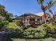Expansive backyard showcasing a screened-in pool area, lush landscaping, and manicured lawn at 4358 Via Del Villetti Dr, Venice, FL 34293