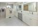 Bright bathroom showcasing a double sink vanity, and a glass door shower at 4358 Via Del Villetti Dr, Venice, FL 34293