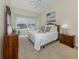 Cozy bedroom featuring a large window, plush carpeting, and a dresser at 4358 Via Del Villetti Dr, Venice, FL 34293