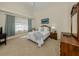 Comfortable bedroom featuring high ceilings, soft natural light, and relaxing decor at 4358 Via Del Villetti Dr, Venice, FL 34293