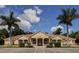 Community clubhouse with a tile roof, lush landscaping, and dedicated accessible parking spaces at 4358 Via Del Villetti Dr, Venice, FL 34293