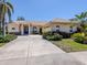 Charming single-story home with lush landscaping, a tile roof, and a blue front door at 4358 Via Del Villetti Dr, Venice, FL 34293