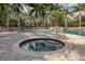 Relaxing community hot tub with a brick surround, perfect for unwinding after a long day at 4358 Via Del Villetti Dr, Venice, FL 34293