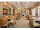 Interior of community room featuring neutral colors, fireplace and plenty of seating at round tables at 4358 Via Del Villetti Dr, Venice, FL 34293