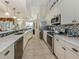 Stylish kitchen featuring stainless appliances, elegant white cabinetry, granite countertops and a decorative tile backsplash at 4358 Via Del Villetti Dr, Venice, FL 34293