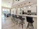 Modern kitchen with sleek countertops, barstool seating, and stainless steel appliances at 4358 Via Del Villetti Dr, Venice, FL 34293