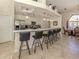 Kitchen bar with black barstools and access to the dining room, stainless steel appliances at 4358 Via Del Villetti Dr, Venice, FL 34293