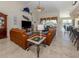 Open-concept living room with tile flooring, leather sofas, and decorative fish wall art at 4358 Via Del Villetti Dr, Venice, FL 34293