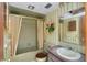 Bathroom featuring vintage green tile, tub, and matching fixtures at 440 Monza Ave, North Port, FL 34287