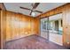 Bedroom featuring wooden paneling, with sliding doors to the lanai at 440 Monza Ave, North Port, FL 34287