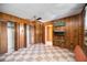 Bedroom with wood paneling, checkered tile floor, and ceiling fan at 440 Monza Ave, North Port, FL 34287