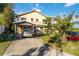Two story house with a carport and long concrete driveway at 440 Monza Ave, North Port, FL 34287