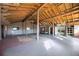 Open great room featuring natural light, wooden beams and posts, and unique architectural details at 440 Monza Ave, North Port, FL 34287