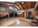 Great room features a vaulted ceiling, wood paneling, and a second floor balcony at 440 Monza Ave, North Port, FL 34287