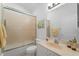 Bathroom featuring marble counter tops, neutral walls, and a frosted glass shower door at 4553 Fairway Dr, North Port, FL 34287