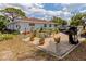 Backyard with outdoor patio featuring paver flooring, grill, patio table and chairs and landscaping at 510 Airport E Ave # 2D, Venice, FL 34285