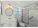 Clean bathroom featuring a shower with sliding doors, a vanity and a mirror at 510 Airport E Ave # 2D, Venice, FL 34285
