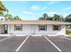 Inviting exterior of a one-story home featuring ample parking and a clean, white facade at 510 Airport E Ave # 2D, Venice, FL 34285